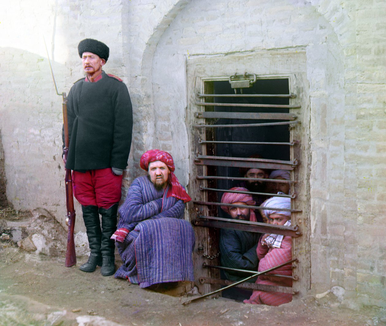 Zindan prison, with inmates and a guard with Russian rifle, uniform, and boots, Central Asia, Russian Empire, between 1905 and 1915 by Sergey Prokudin Gorsky