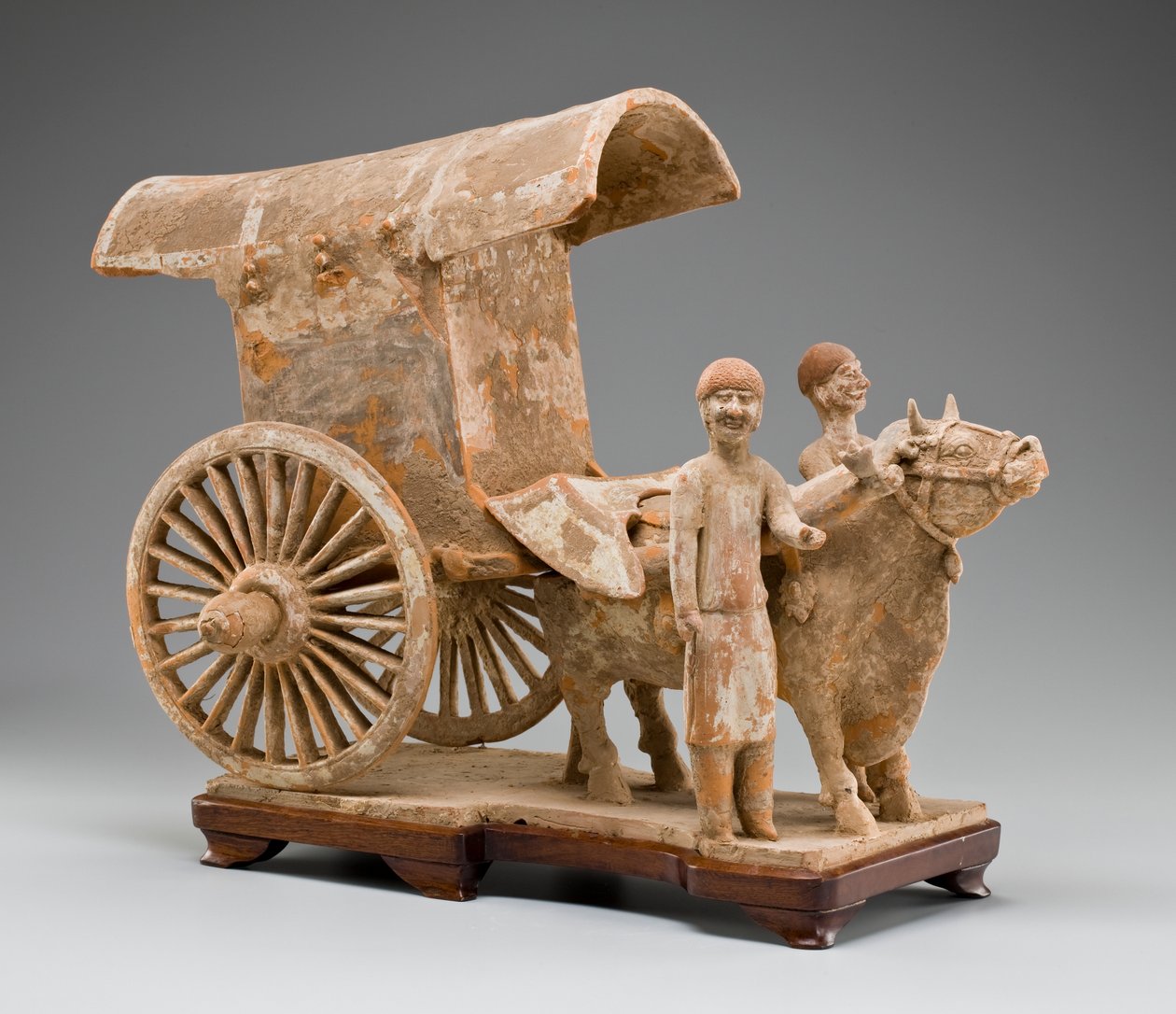 Two-wheeled ox cart with ox and two standing attendants by Tang Dynasty Chinese School