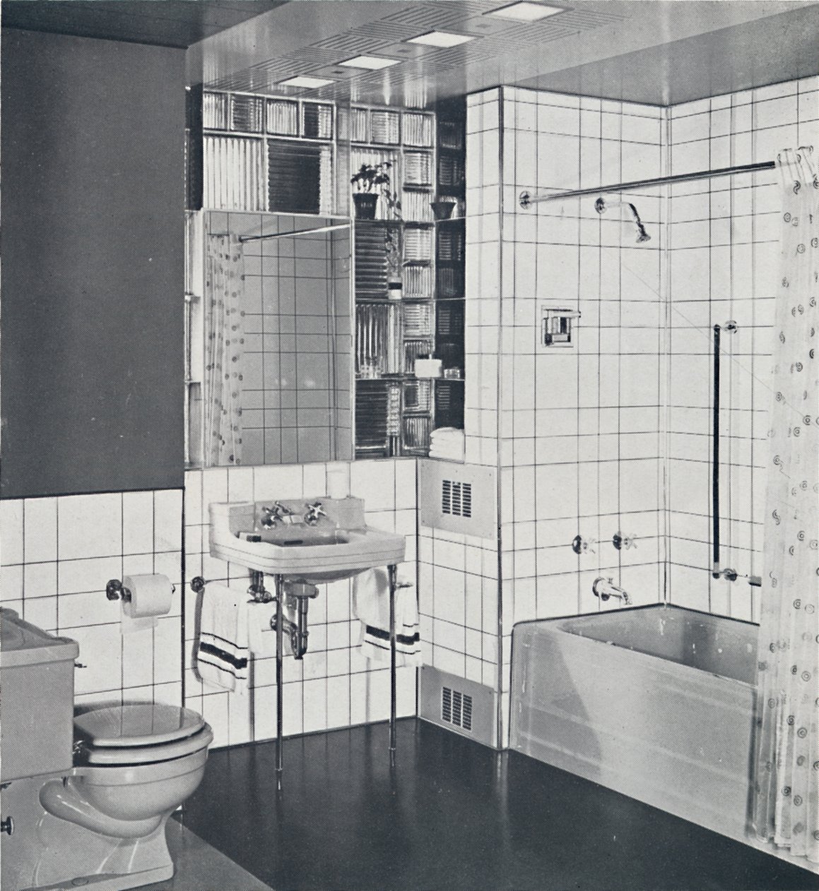 Crane Co. - A compact recess tiled in canary yellow, scored with orange, showing the stainless-steel by Unbekannt