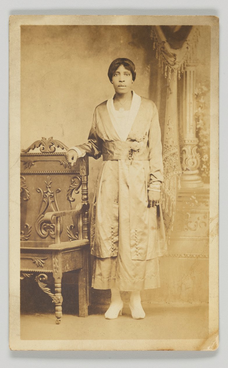 Photographic Postcard of a Woman Standing Next to a Wooden Chair, 1904-1918 by Unbekannt