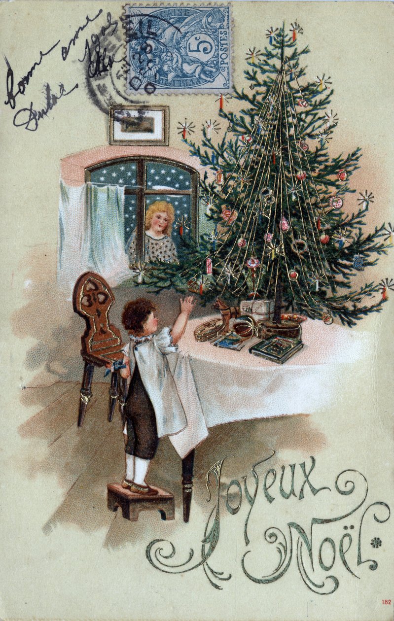 Christmas greeting card: a child in front of a Christmas tree poses on a table, observed by an angel in the window by Unbekannt