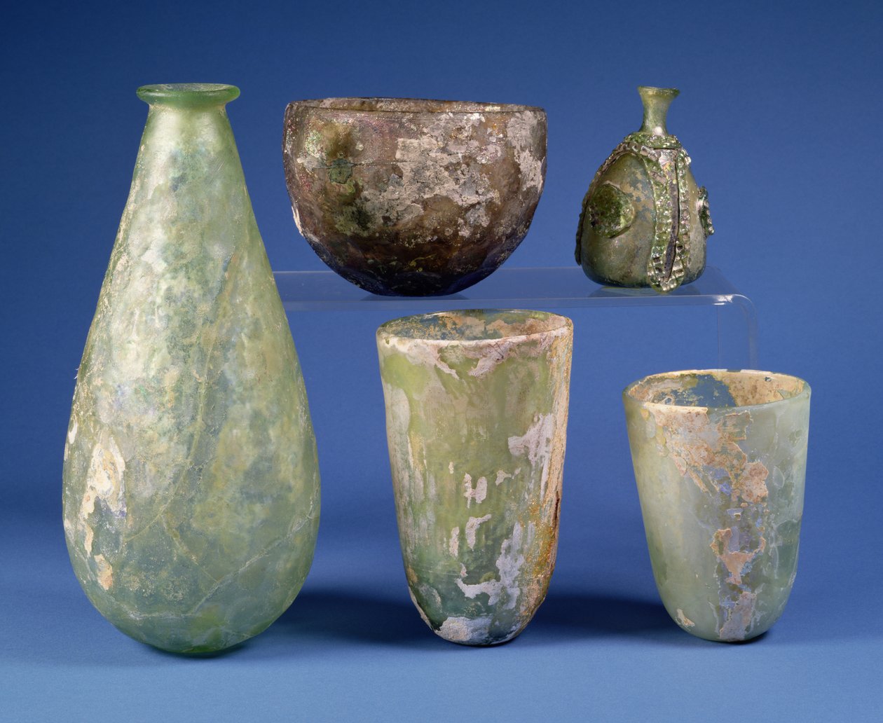 Clockwise from left: pear-shaped green glass flask, Sasanian, 3rd-7th ...