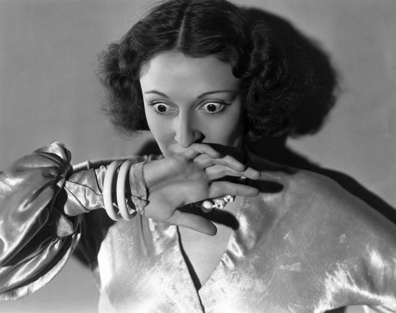 Hollywood, California: c.1932 Close-up of a young woman covering her mouth in fright by Unbekannt