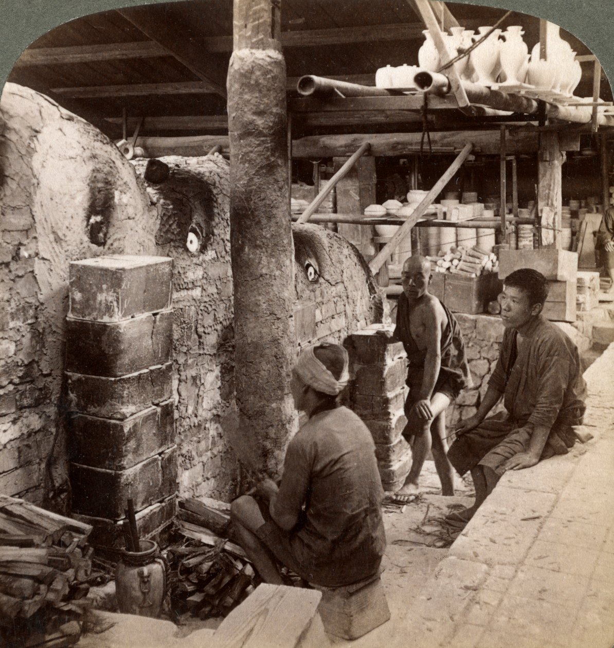Workmen watching kilns full of Awata porcelain, Kinkosan works, Kyoto, Japan, 1904 by Underwood and Underwood
