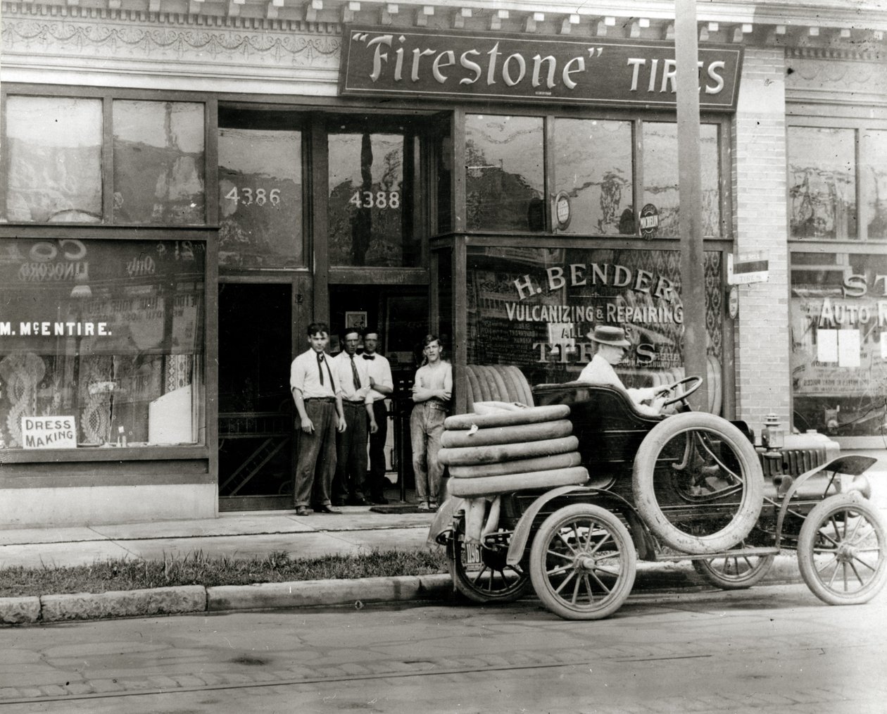 Men and Automobile Tire Repair Truck Gathered Outside the H. Bender Firestone Tire Dealership at 4388 Olive Street by Unknown