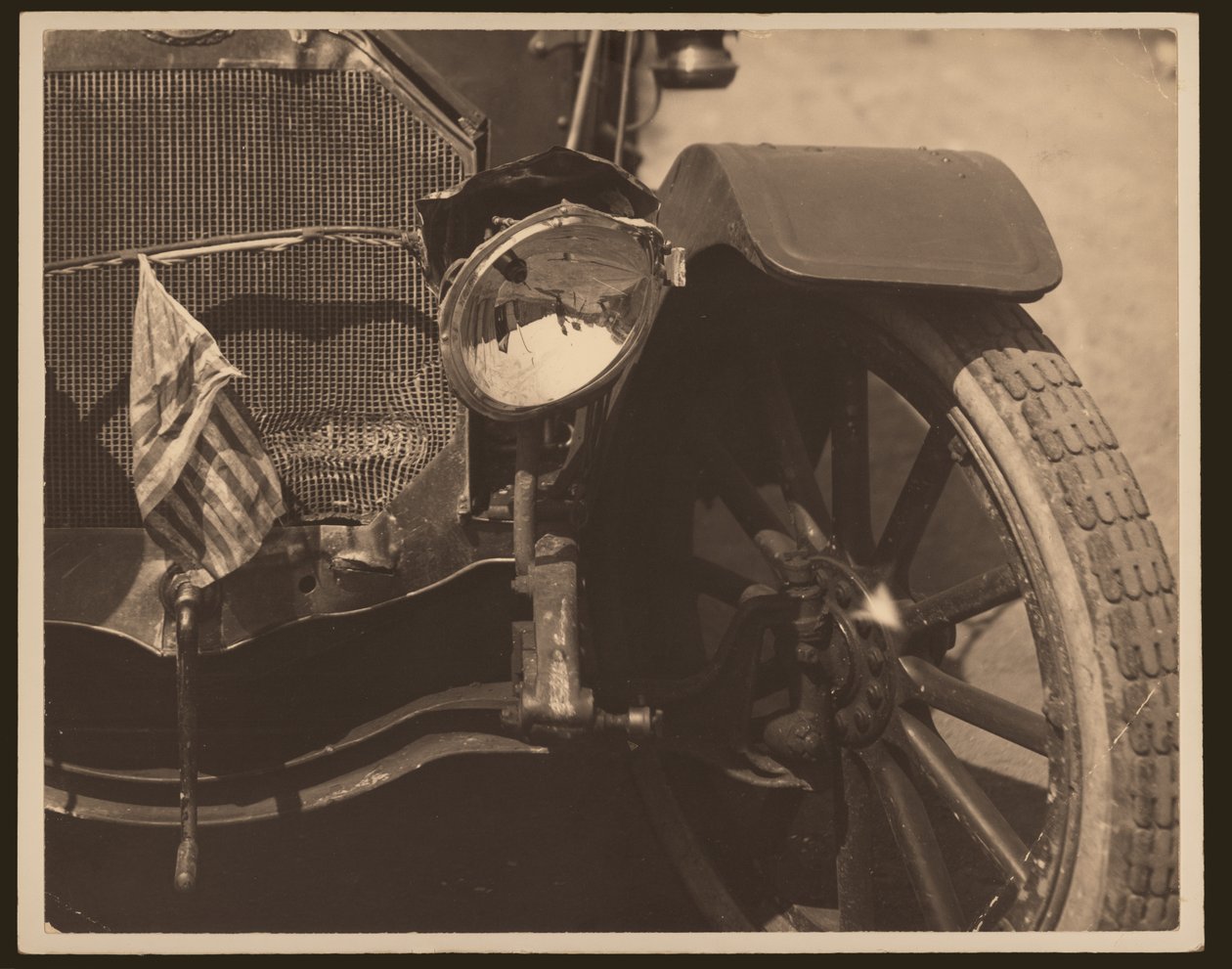 Close-up of Damaged Headlight and Grill on Automobile by William G. Swekosky