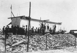 Several men around an enormous block of marble already squared off, just transported to the valley from the quarries in the Apuan Alps by A. Corsini