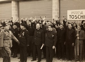 The construction workers of the Company Mauro Toschi fu Ulisse, salute the Duce Benito Mussolini during Inauguration of the buildings of the Royal Airport 