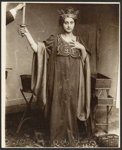 Female Model Wearing Crown and Holding Sword