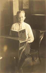Boy reading Kidnapped by American Photographer