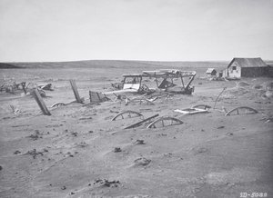 Car and farm machinery buried by dust and sand, Dallas, South Dakota by American Photographer