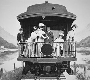Tourists taking scenic photographs from the rear observation platform of a Union Pacific train