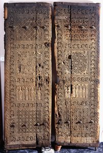 A Pair of Carved Armenian Walnut Doors, Depicting Christ with Six Apostles and Saints