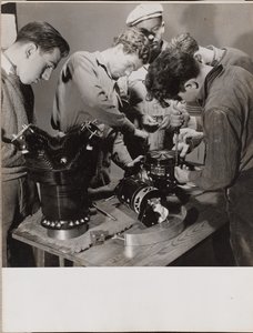 Five Young Men Work Around a Work Bench by Arnold Eagle