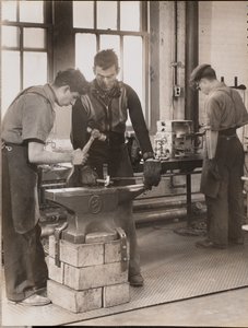 Two Men Hammer Metal on an Anvil