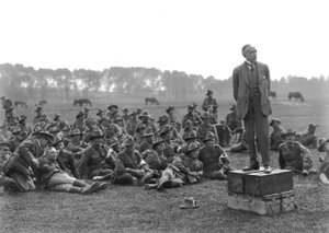 The Right Honourable William Morris (Billy) Hughes, standing on a platform composed of four ammunition boxes, addressing a gathering of the 5th Australian Field Ambulance, near La Motte by Australian Photographer