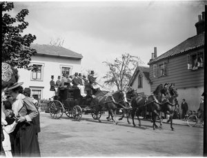 A horse-drawn coach driving past a group of cottages, Greater London Authority