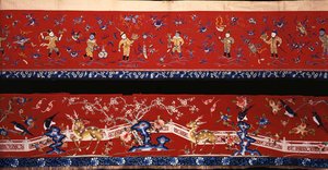 Two Chinese Horizontal Hangings of Red Wool, One Embroidered Predominantly in Shades of Blue Silks Depicting Boys at Play in Gilt Threads