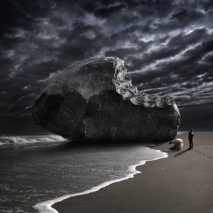 Bitten Rock on Stormy Beach by Christophe Kiciak