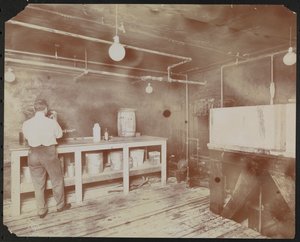 Film laboratories at Carlton Motion Picture Co. with five men and one woman working with film, New York