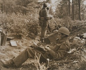 War correspondent Alan Wood typing out a despatch by D.M. Sgt. Smith