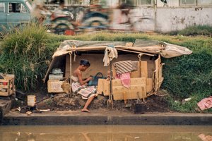 Cardboard hut, along a sewage canal, serves as a home. Jakarta, Indonesia by Dean Conger