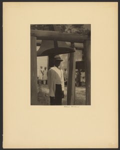Black Man Standing Under a Bell
