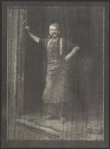 Blacksmith Standing in Doorway, Pipe in Mouth by Doris Ulmann