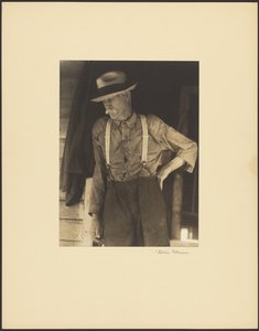 Mustached Old Man with Straw Hat and Suspenders Standing in Doorway