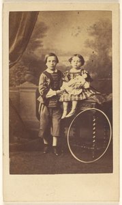 Unidentified Little Boy Standing Next to an Unidentified Little Girl Seated on a Table, a Large Hoop Resting on a Table Leg by Désiré Durand