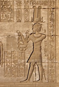 Roman mammisi commemorating the birth of Ihy, son of Isis - Detail of reliefs and hieroglyphs: Emperor Trajan carrying offerings to the goddess Hathor - Temple of Hathor, Denderah, Egypt