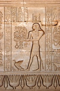 Egyptian antiquity: representation of a man bringing offerings to the goddess, Temple of Hathor, Denderah, Egypt - Egyptian civilization: a man carrying offerings to the goddess Hathor, carved on the wall of Hathor Temple (or Temple of Tentyra) in Denderah by Egyptian Ptolemaic Period