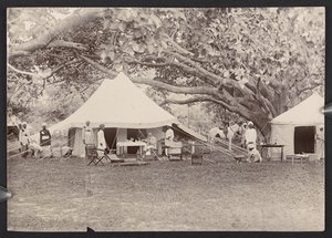 J.J. Cotton in topi and tent (b/w photo) by English Photographer
