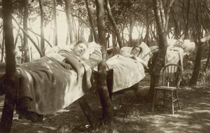 Hop pickers sleeping in hammocks on a farm in Kent by English Photographer