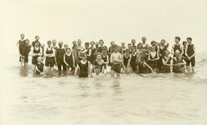 Large group of swimmers standing in the water by English Photographer