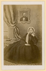 Queen Victoria, when a widow, with a portrait of the Prince Consort behind her by English Photographer
