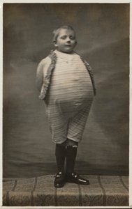 School Boy, Dressed Up to Have a Very Large Stomach by English Photographer
