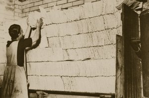 Stacking unleavened bread for the Passover in a Hebrew bakery by English Photographer