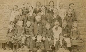 Teacher Posing for a Portrait with His Pupils by English Photographer