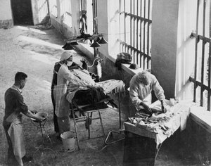 A Field Surgery Unit operating in an Italian prison under fire during World War Two, from a collection of 650 photographs compiled by the Command Association by English School