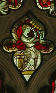 A window in the Lady Chapel depicting a musician angel with bells by English School