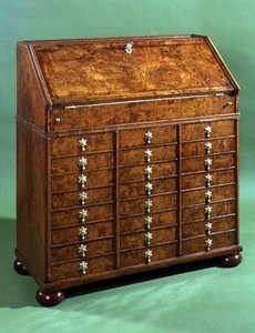 Bureau with many small drawers and bun feet