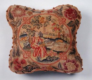 Cushion, embroidered in petit point, depicting a woman in a landscape by English School