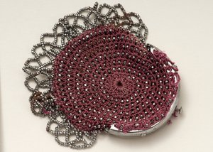 Pink purse with top clasp, bead decoration and mesh trim by English School