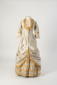 Princess line evening dress of grey and white narrow striped silk trimmed with net covered yellow silk taffeta ruched ribbon