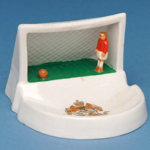 Rare armorial souvenir of Douglas, Isle of Man, showing a goalkeeper in his goal (ceramic)