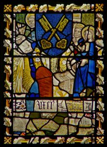 The east window depicting St John, St Peter at the Gate, shield with a symbol of St Peter