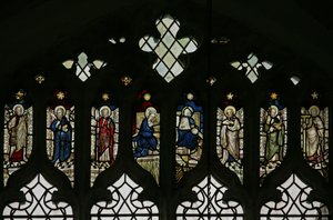 Window depicting tracery lights with an array of saints including Philip, Bartholomew, Matthias, Simon, Jude, and Thomas with the Coronation of the Virgin at the center by English School