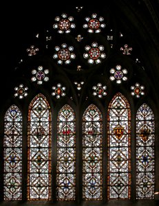 Window s5 depicting geometric grisaille and roundels in the tracery lights by English School