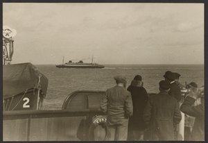 Group of People on the Deck of a Ship Watching Another Ship Sailing Past in the Distance by Erich Salomon